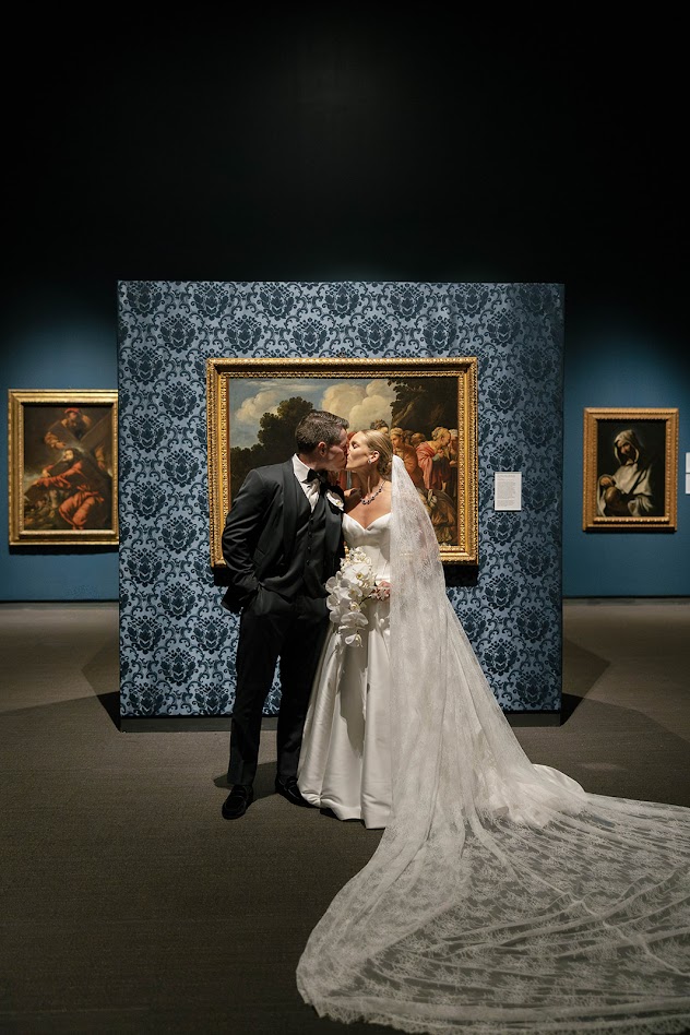 Bride and Groom in front of artwork at the Museum of Fine Art in St Petersburg FLorida. St Petersburg Wedding Rentals. Gold Chiavari Chairs. Tampa Wedding Rentals. Wedding rentals Tampa