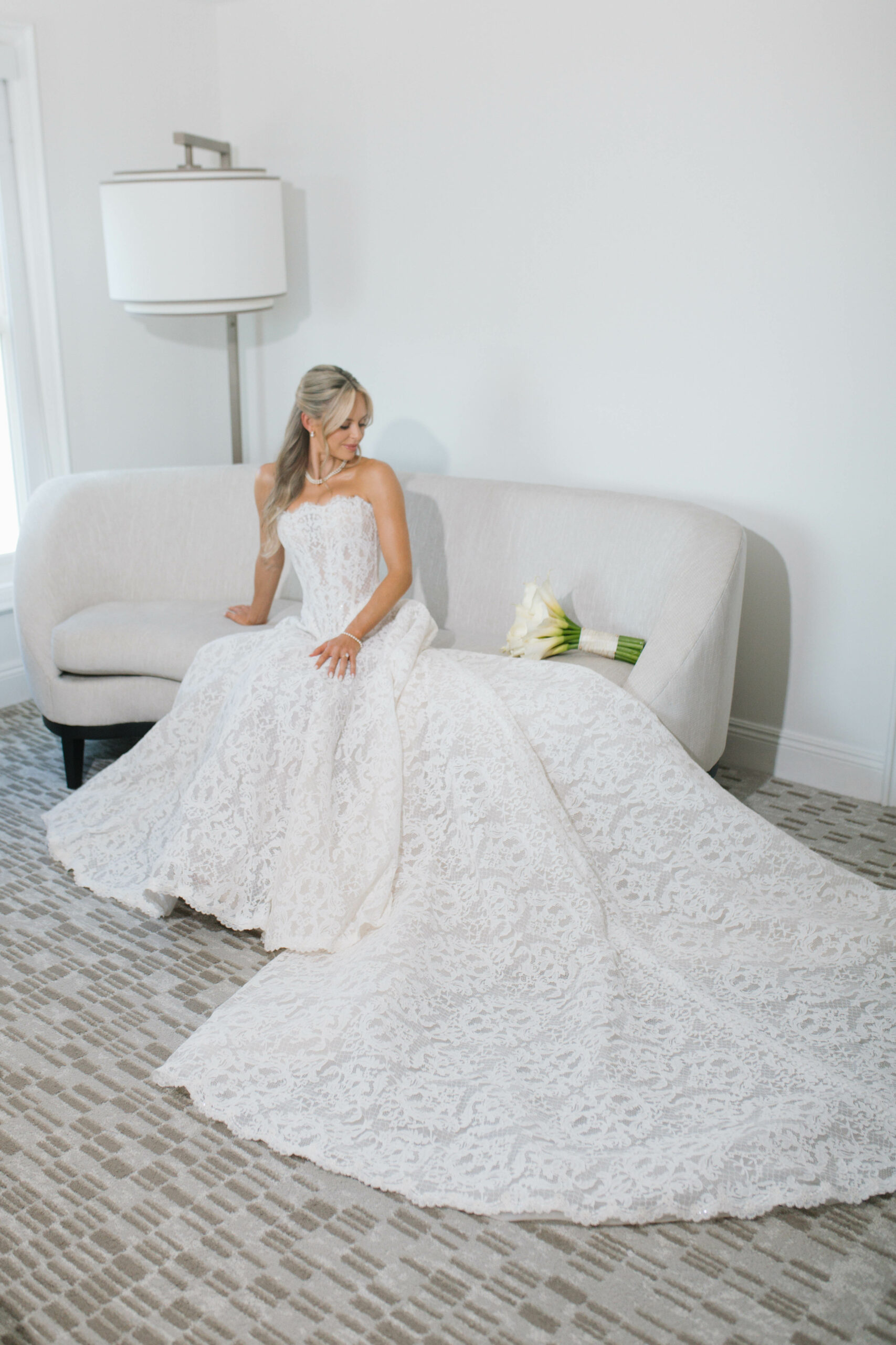 Bride on couch with makeup and hair by LeJeune Artistry. Orlando Wedding Rentals