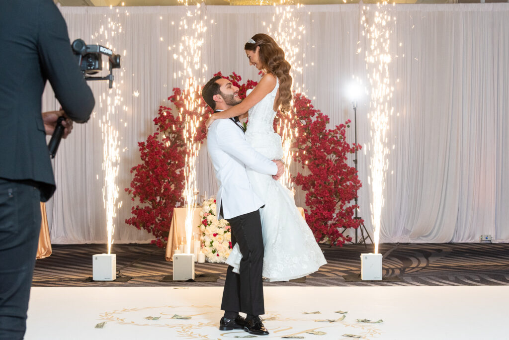 Bride and Groom on dancefloor with sparklers and lifted in air. Tampa Bay Weddings. Tampa Bay Wedding Rentals. Tampa Bay Chiavari CHairs. Central Florida Wedding Rentals.