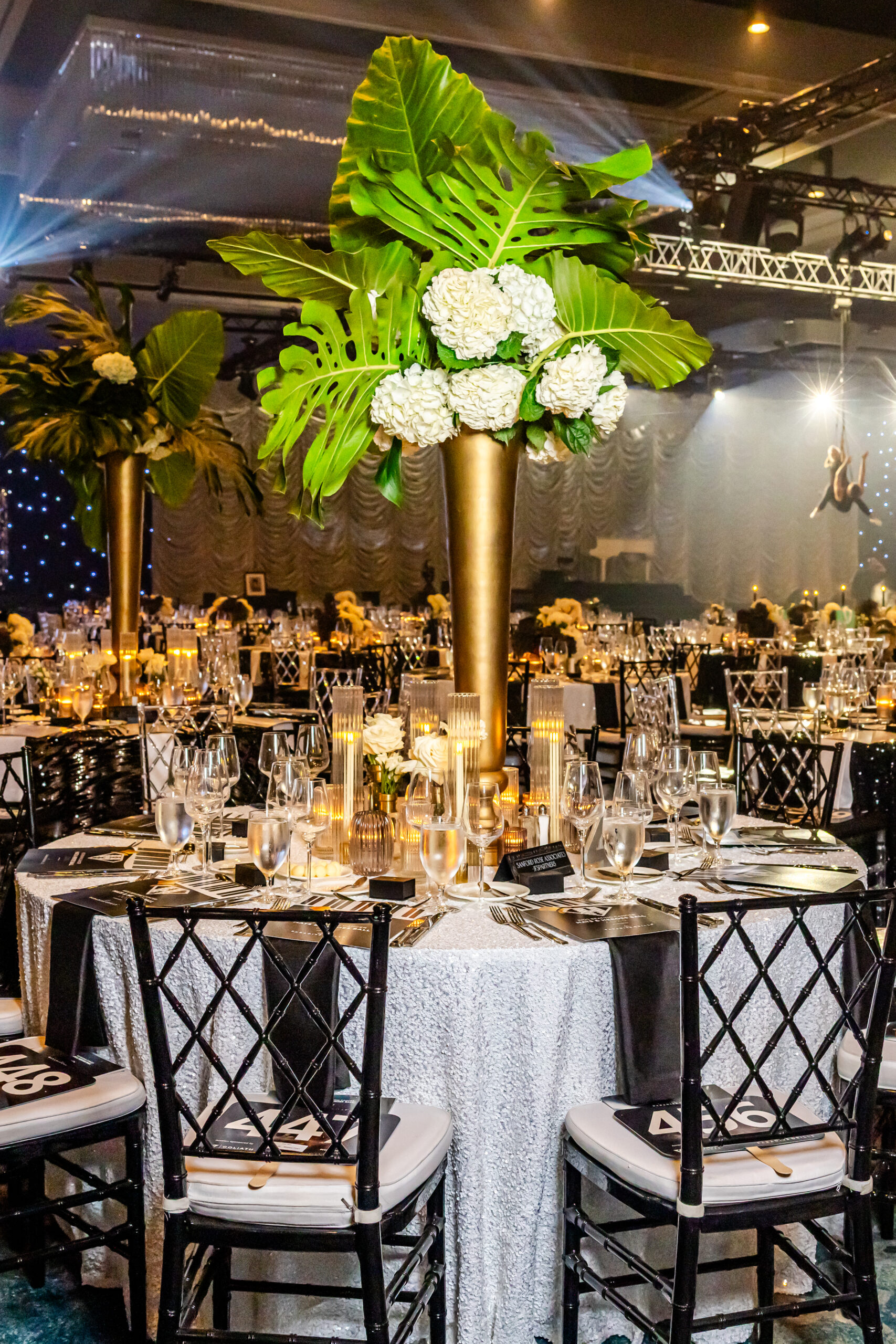 Centerpieces with Black Wysteria Chairs from A Chair Affair at Kids Beating Cancer Event 2025. Orlando Event Rentals. Orlando Events. Chiavari Chair Rentals. Wysteria Chair Rentals. Central Florida Chair Rentals.