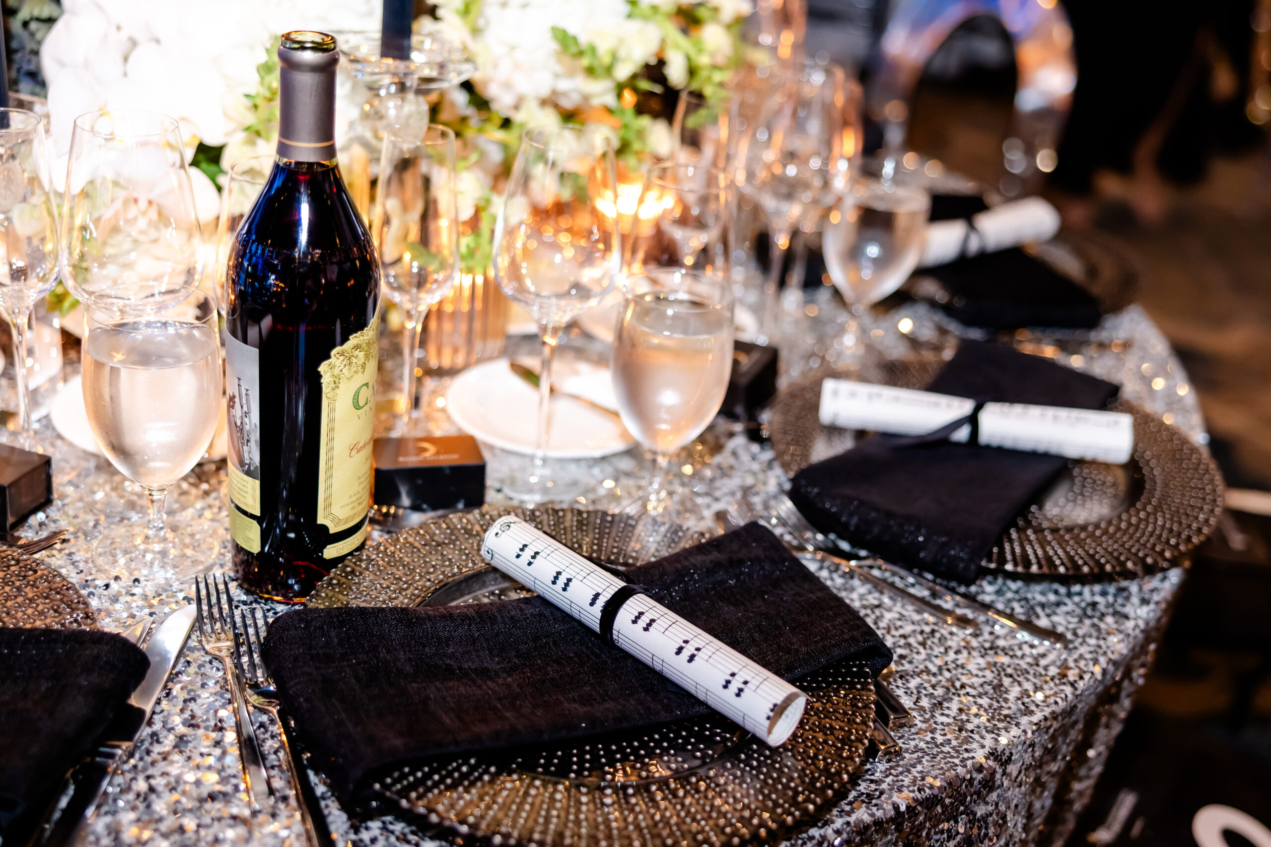 Table View with Silver Glitter Chargers from A Chair Affair at Kids Beating Cancer Event 2025. Orlando Event Rentals. Orlando Events. Chiavari Chair Rentals. Wysteria Chair Rentals. Orlando Charger Rental. Central Florida Charger Rentals