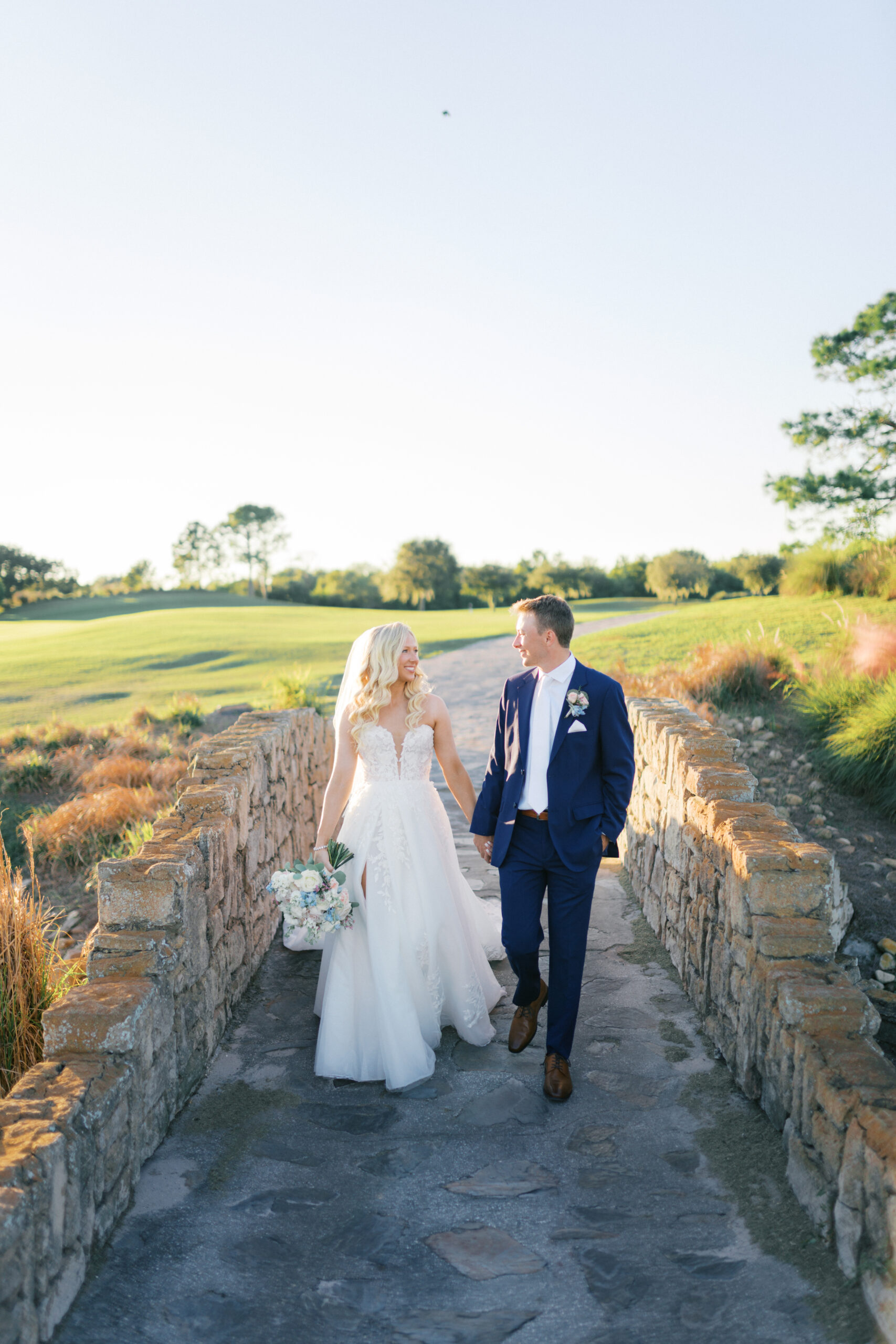 Bride and Groom on stone bridge. St Petersburg Wedding Rentals. St Petersburg Weddings. Silver Chiavari Chairs. Chiavari Chair Rentals Florida. Florida Wedding Rentals.