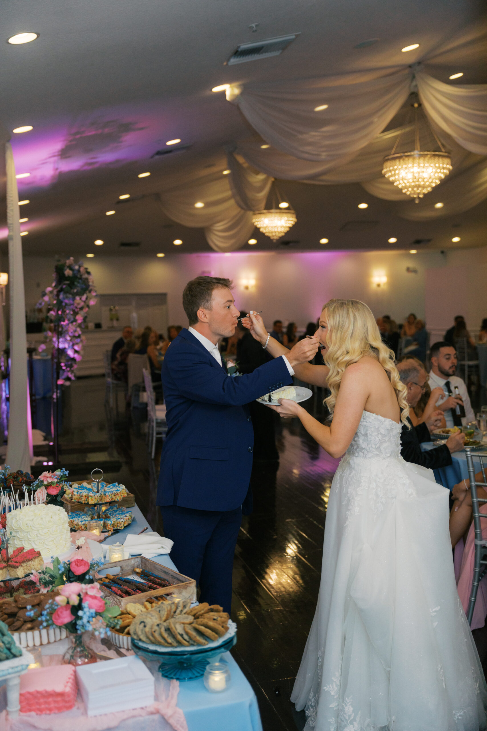 Bride and Groom feeding each other cake