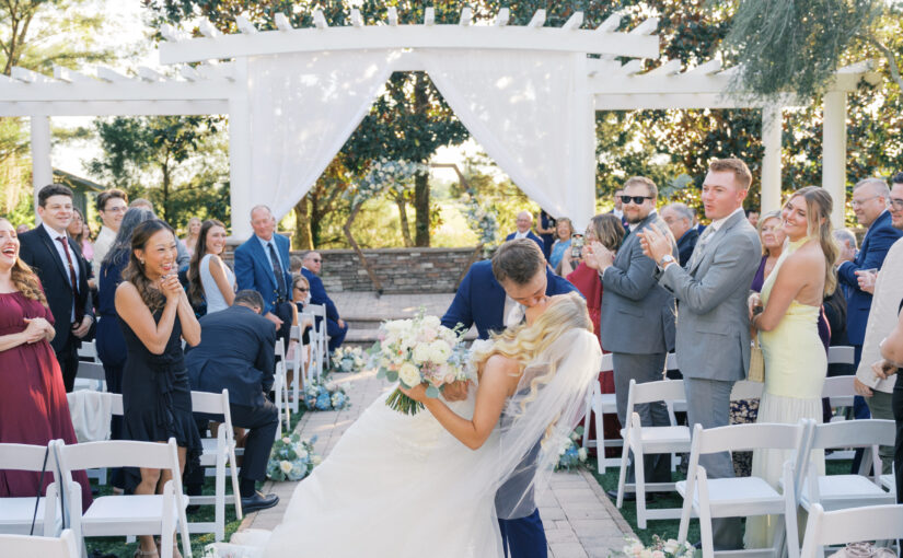Bride and Groom kissing after ceremony. Orlando Wedding Rentals. Orlando Chair Rentals. Orlando Chiavari Chair Rentals. Orlando Charger Rentals.