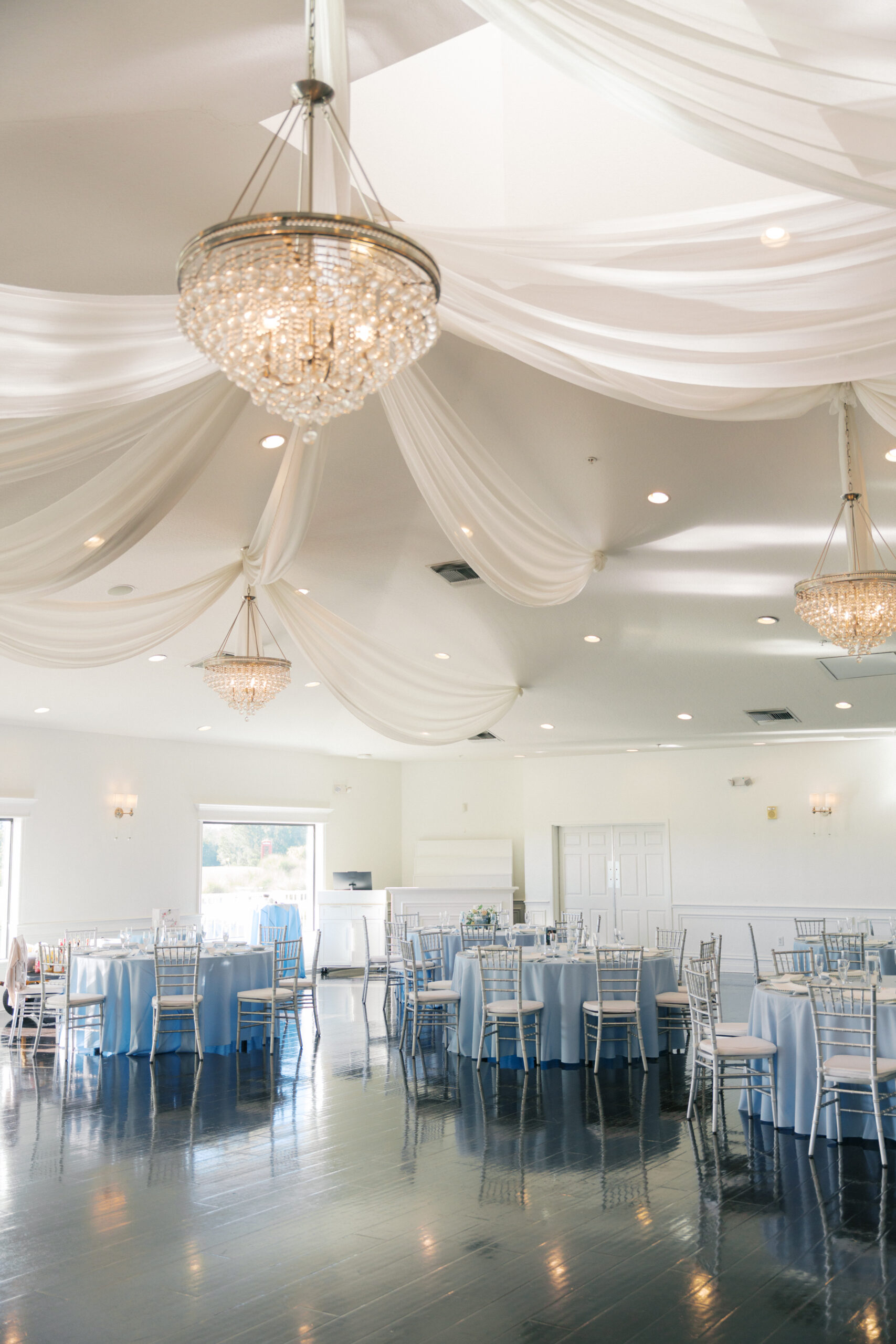Reception from a distance with Silver Chiavari Chairs and Silver Belmont Chargers from A Chair Affair. St Petersburg Wedding Rentals. St Petersburg Weddings. Silver Chiavari Chairs. Chiavari Chair Rentals Florida. Florida Wedding Rentals.