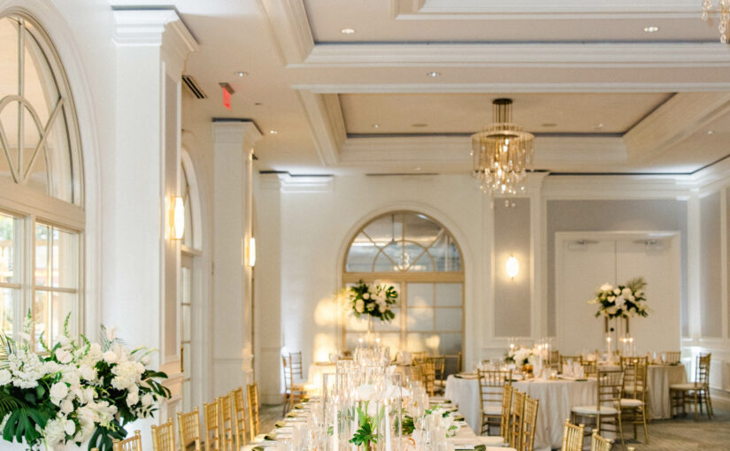Table view long with Gold Chiavari Chairs and Gold Rimmed Chargers from A Chair Affair. Sarasota Wedding Rentals. Sarasota Chiavari Rentals. Central Florida Wedding Rentals. Tampa Wedding Rentals. Tampa Chair Rentals.