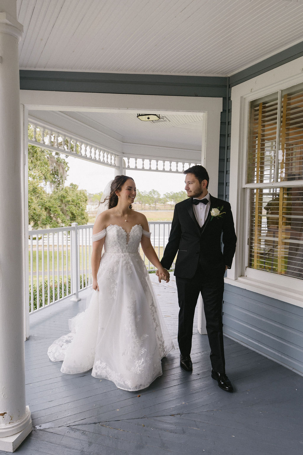 Bride and Groom in front of porch at Highland Manor