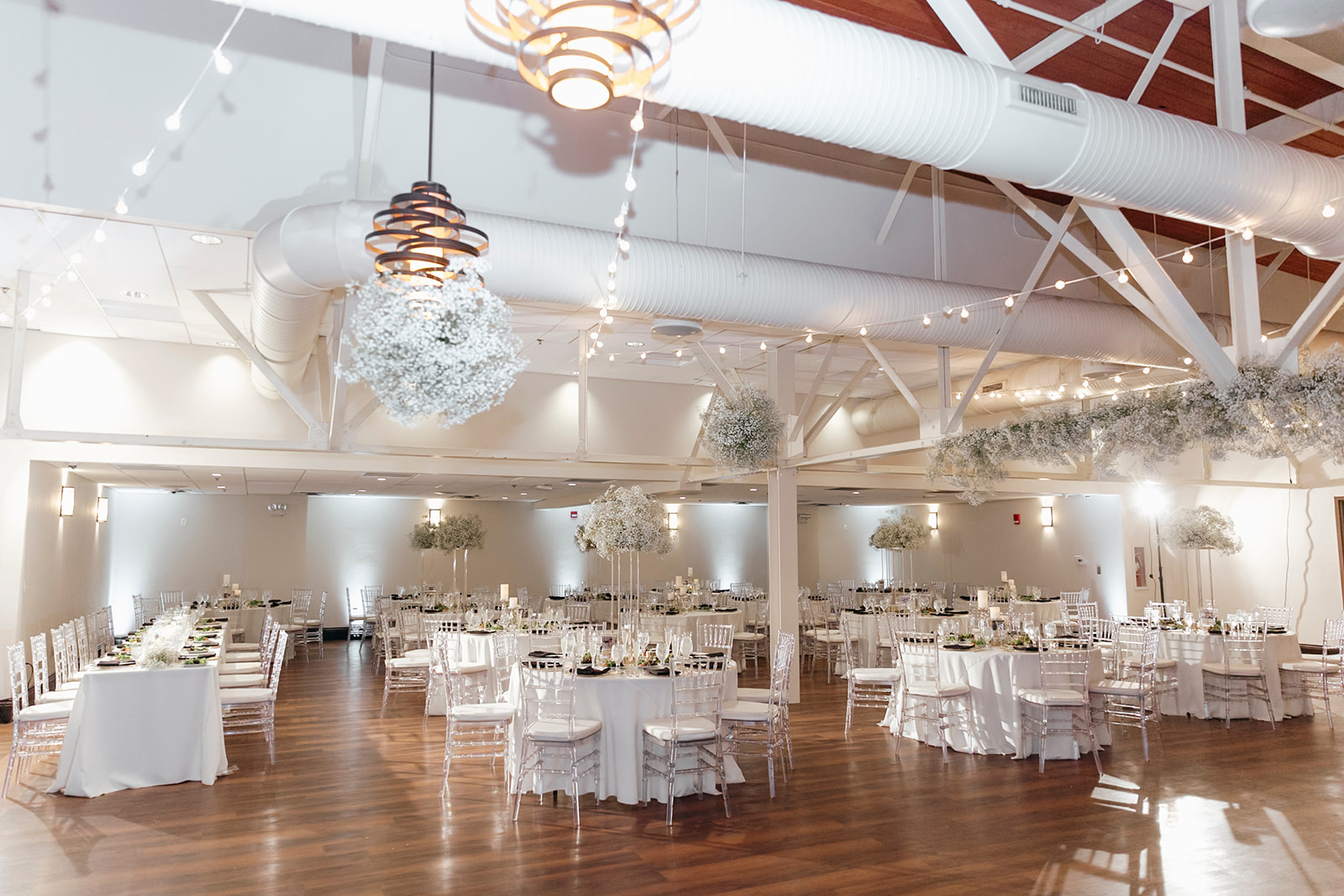 Room view with Clear Chiavari Chairs from A Chair Affair and Gold Rim Glass Chargers from A Chair Affair.