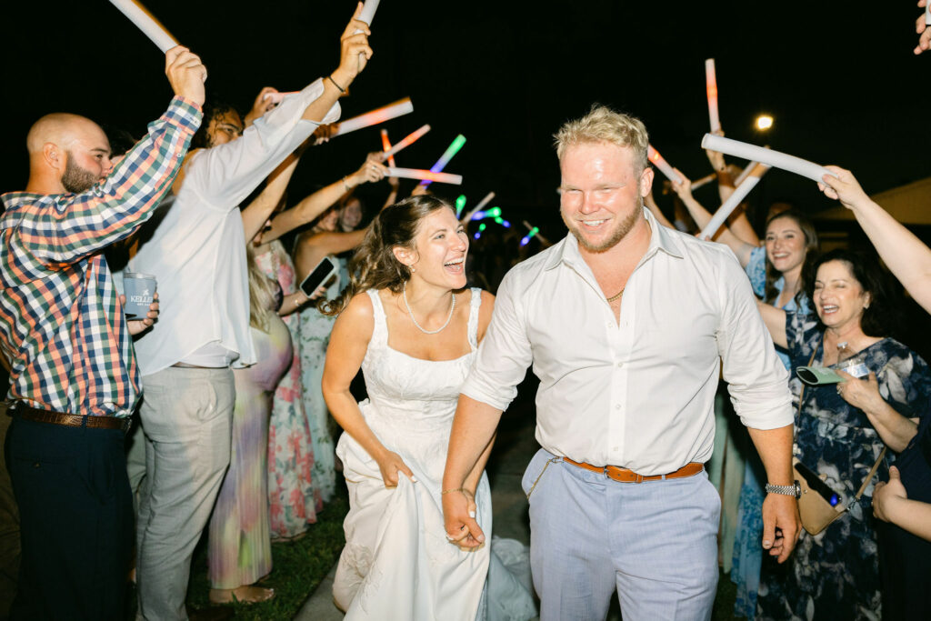 Bride and Groom exiting through a tunnel of light sticks