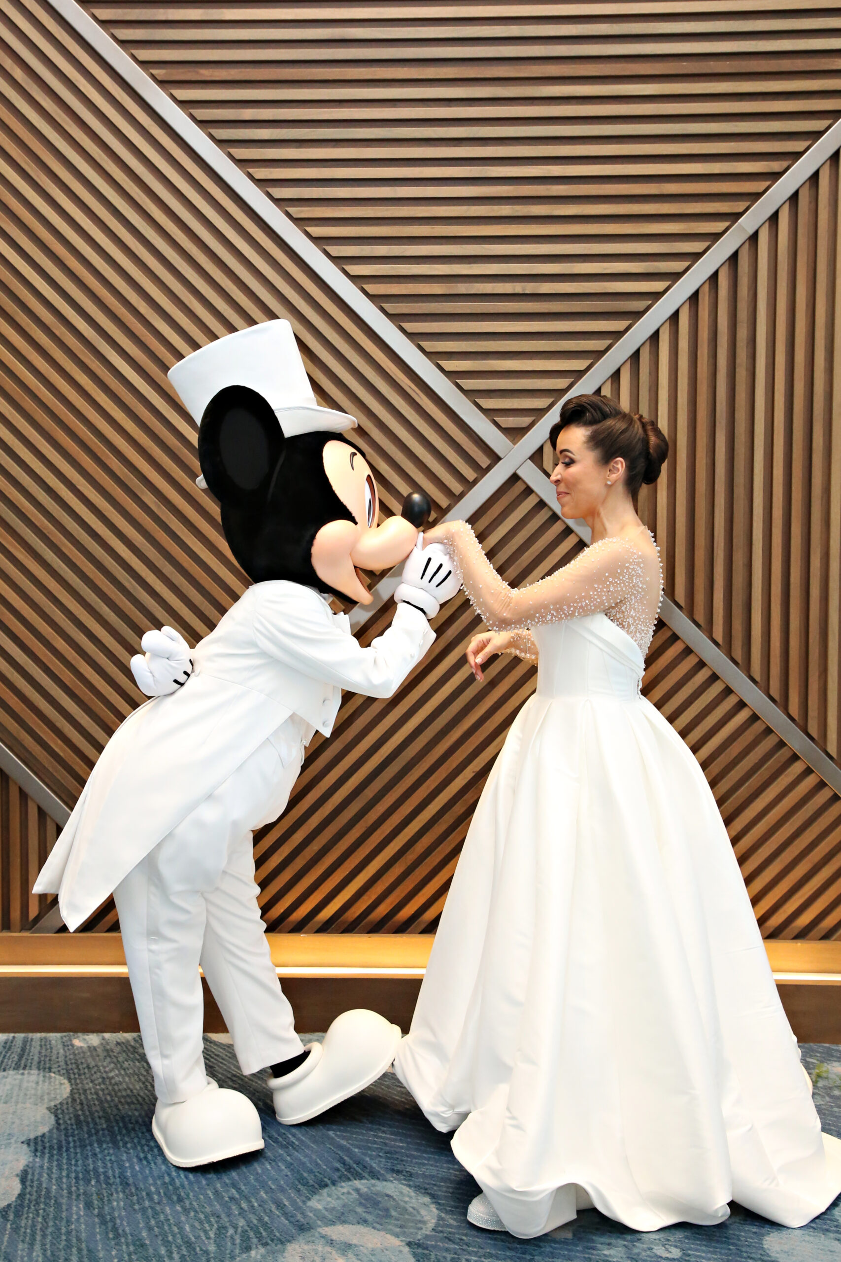 Mickey Mouse kissing the brides hand