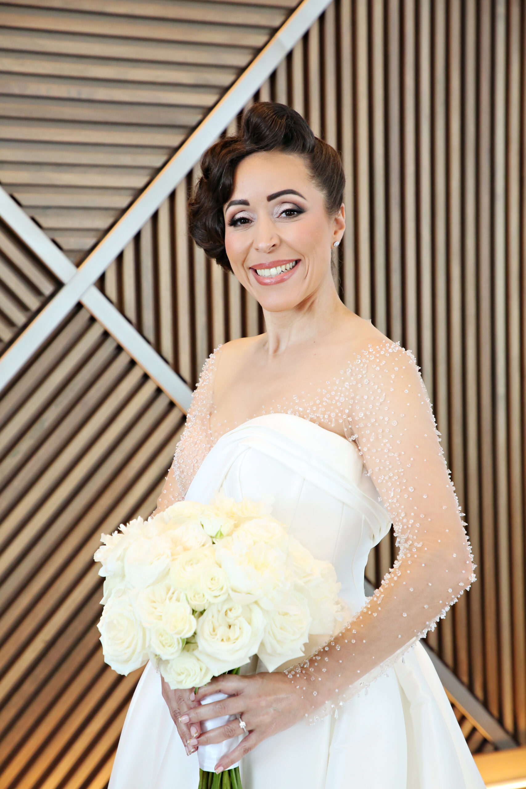 Bride with floral bouquet. Central Florida Wedding Rentals. Orlando Wedding Rentals. Chiavari Chair Rentals. Gold Chiavari Chairs. Walt Disney World. Swan and Dolphin Resort.