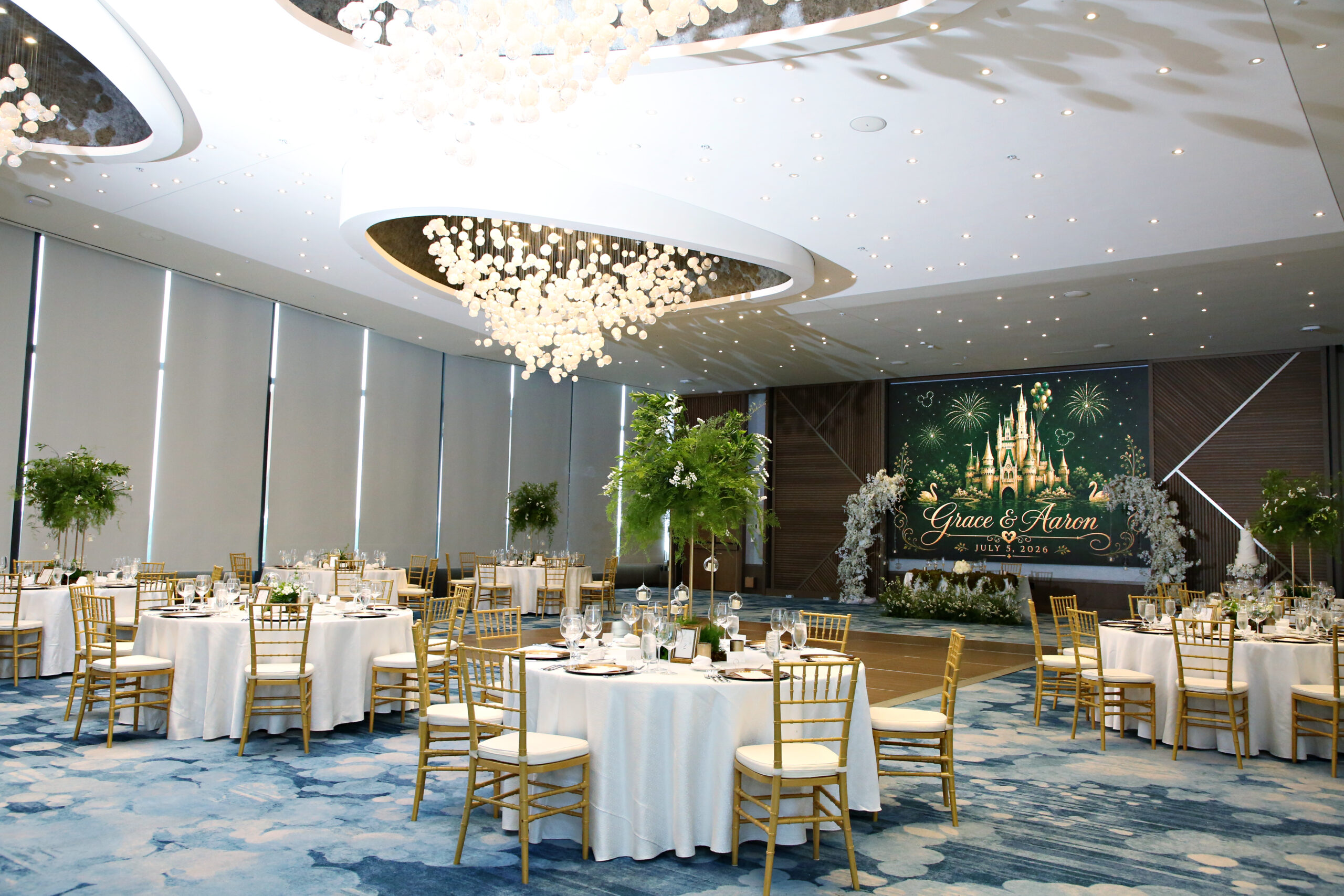 Room overview of The Vue ballroom at Walt Disney World's Swan and Dolphin Resort with Gold Chiavari Chairs and White Chair Pads provided by A Chair Affair. Central Florida Wedding Rentals. Orlando Wedding Rentals. Chiavari Chair Rentals. Gold Chiavari Chairs. Walt Disney World. Swan and Dolphin Resort.